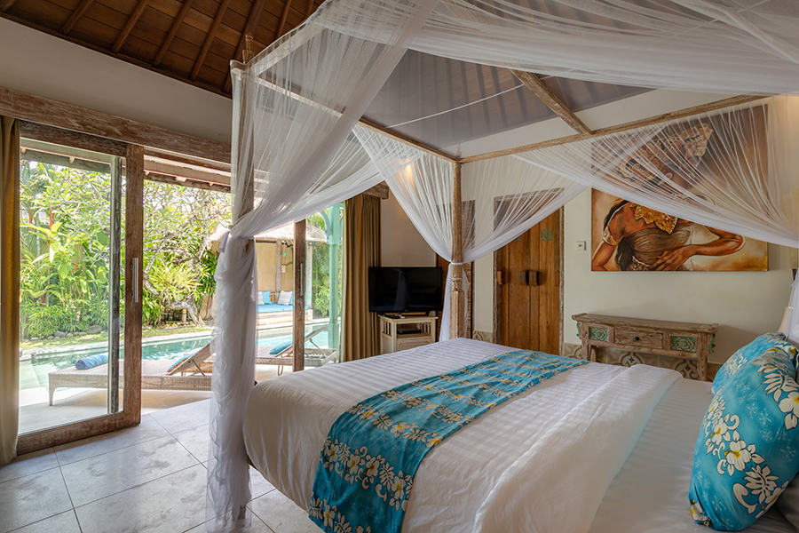 Bedroom overlooking the private pool and luscious garden